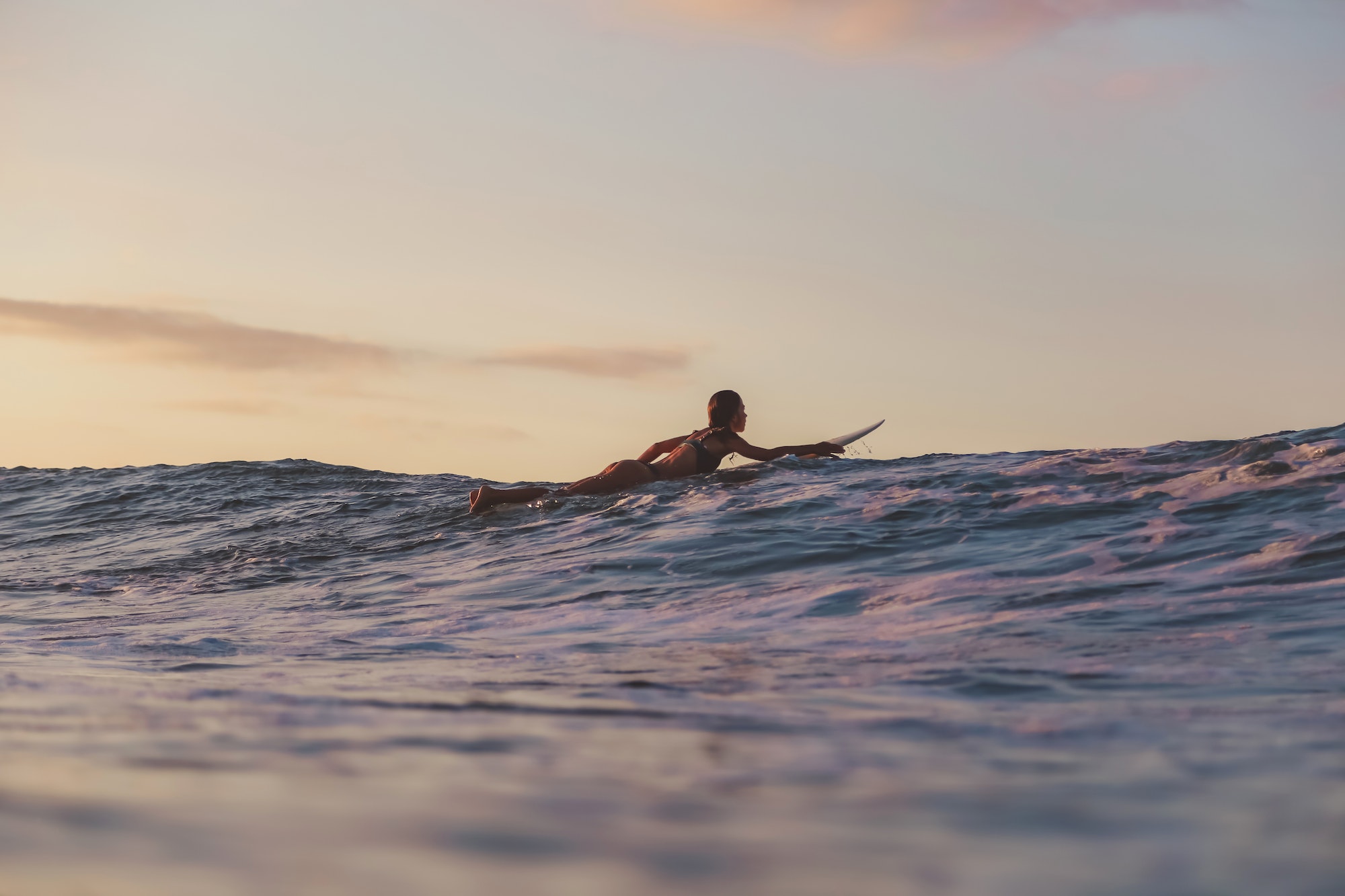 woman on surf board floating on water